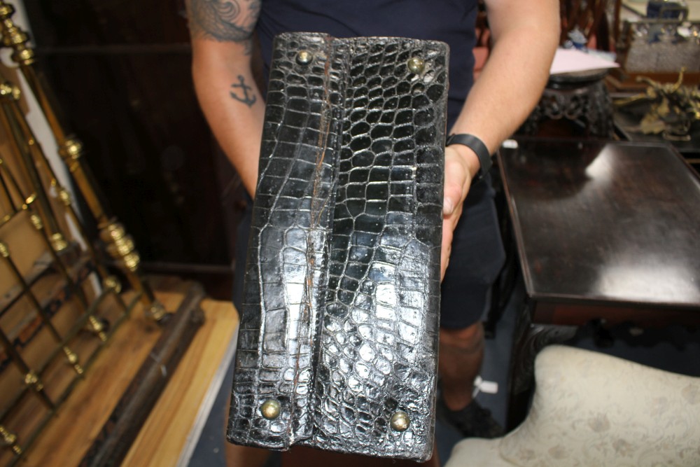 An early 20th century black crocodile toilet case, 40 x 33 x 18cm